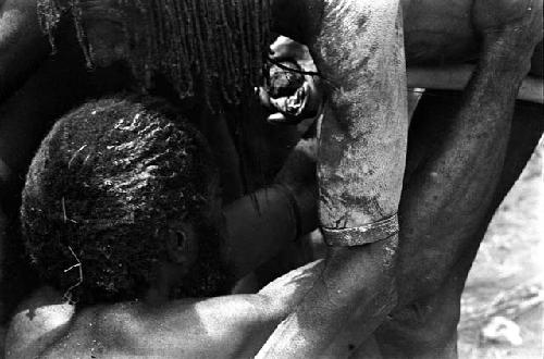 Detail of two men greeting each other at the funeral