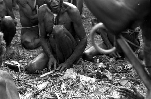 Men eating pig meat