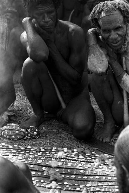 Cowrie bands of nyeraken aré being laid out on banana leaves