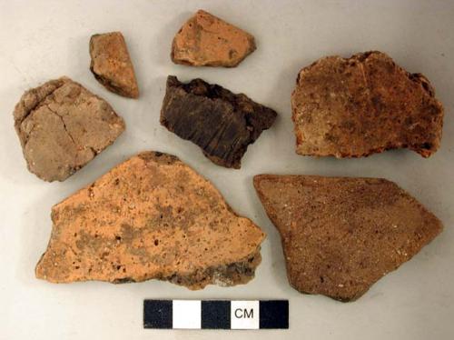 Coarse earthenware body and rim sherds, some undecorated, some cord impressed, some rocker dentate