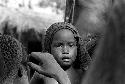 A child peers at the camera from the women's group