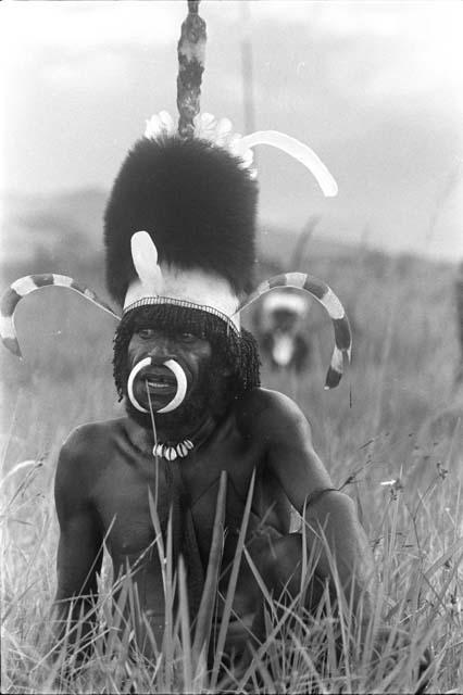 A member of the Kosi-Alua in a beautiful head dress at Etai