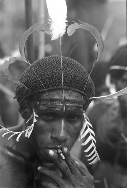 Man smoking a cigarette; different kind of headdress