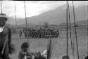 Women dancing; warriors in the foreground