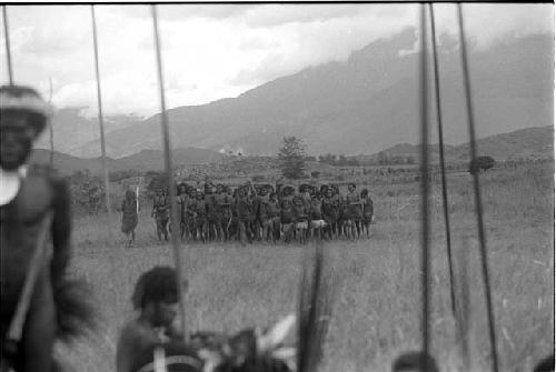 Women dancing; warriors in the foreground