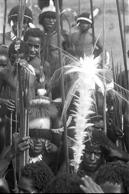 Group of warriors; spears and feather object