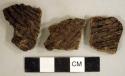 Coarse earthenware body sherds, some cord impressed, one incised; two sherds crossmend