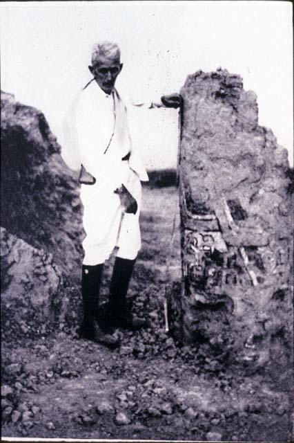 Man standing next to excavated mural