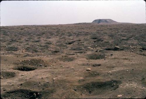 Looting at El Brujo Complex, with Huaca Partida in background