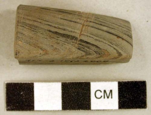 Ground stone object fragment, one grooved surface