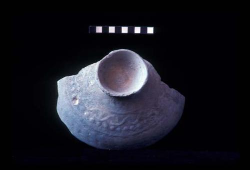 Pedestaled base bowl with low relief design from Site 94