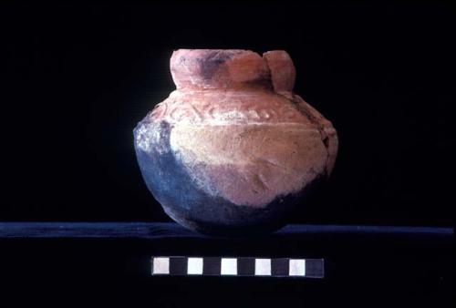 C-neck jar with press molded design and white slip from Site 40