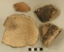 Ceramic, earthenware body, rim, and handle sherds, punctate rim, some punctate, some undecorated, one cord-impressed, shell-tempered; seven body sherds and one rim sherd crossmend