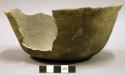 Ceramic vessel, slightly flared rim, sherds missing from body