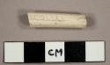 White kaolin pipe stem fragment with "ougall" stamped on one side and "VILRDS' stamped on the other side