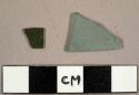 Flat glass fragments, one green and one aqua