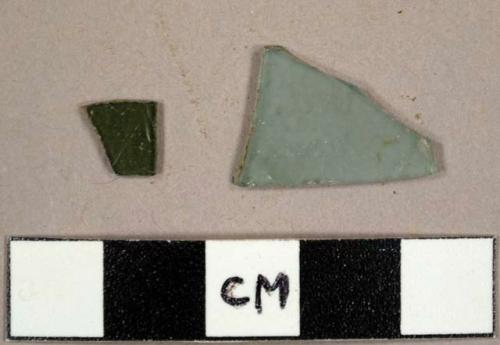 Flat glass fragments, one green and one aqua