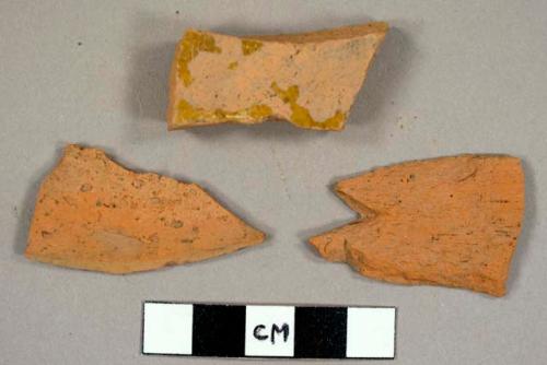 Redware sherds, including one with yellow lead glaze