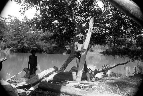 Man and boy with lumber by the river