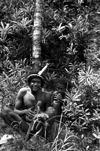 Walimo with his steel axe, sitting with another boy