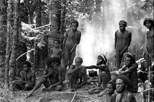 Group of men around the fire outside Robert Gardner's tent