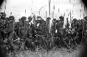 Group of warriors sitting and standing at an Etai