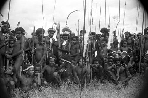 Group of warriors sitting and standing at an Etai