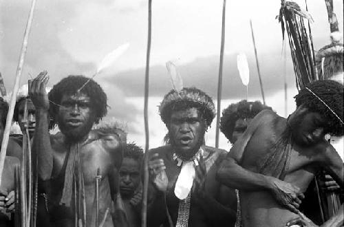 Men standing and singing at an Etai