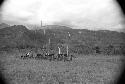 Distant shot of men seated at an Etai