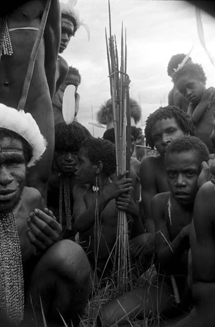 Men seated, waiting to dance at an Etai