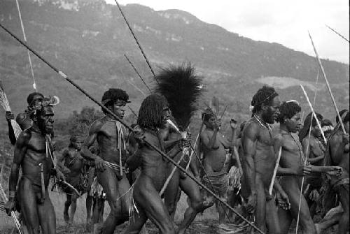 Men dancing at an Etai, spears in hand -- some women among them