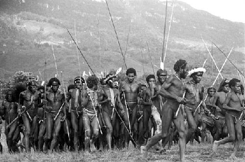 Large group dancing at an Etai, some women among them