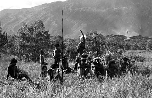 Men seated among the grass, at an Etai