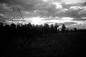 Dancing group of men silhouetted against the low sun