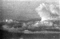 Aerial view of clouds and unidentified land mass