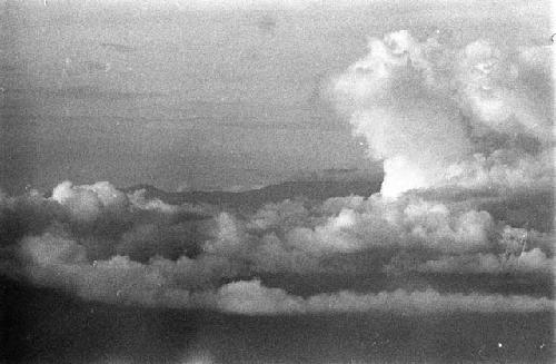 Aerial view of clouds and unidentified land mass