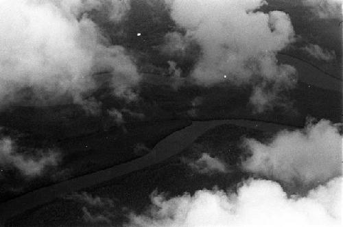 Aerial view of clouds and unidentified rivers and land