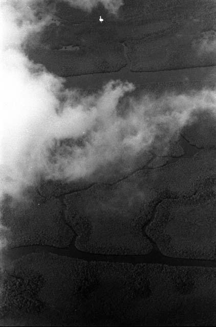 Aerial view of clouds and unidentified rivers and land