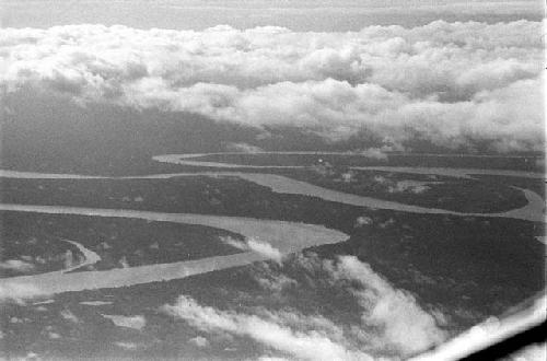 Aerial view of clouds and unidentified rivers and land