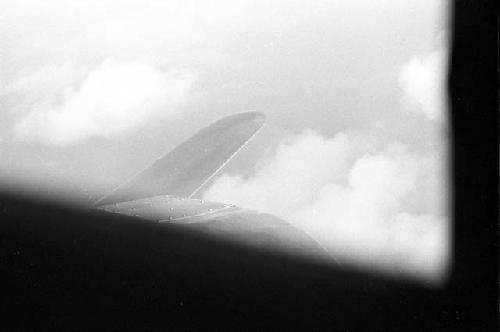 Aerial view of clouds; airplane wing