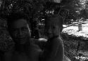 Unknown man and children on a beach in Biak