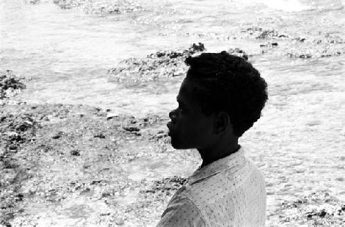 Unknown boy standing on the beach in Biak