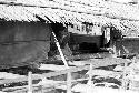 Woman seen from the outside of a building on the water in Biak