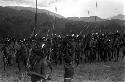 Group of men dancing at an Etai, spears sticking up around them