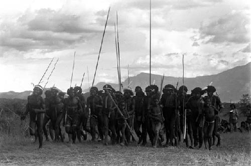 Group of men dancing with spears at an Etai