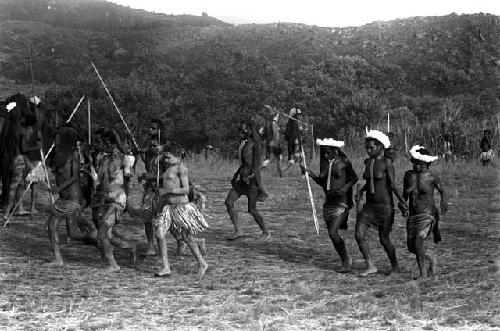 Women dancing at an Etai on the Liberek; three women with feather headdresses at right