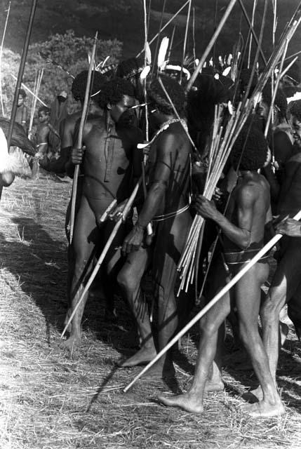 Men's group dancing at an Etai; spears in hand