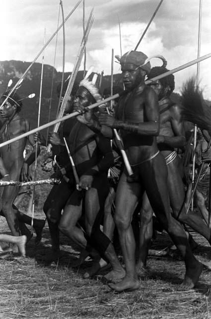 Dancing men's group at an Etai, spears in hand