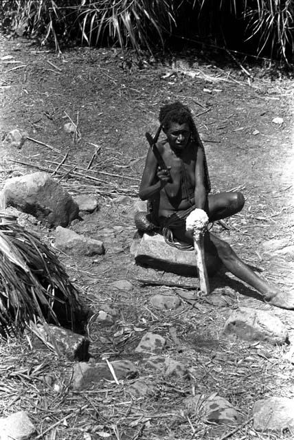 Woman in a sili pounding a haki stalk