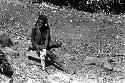 Woman in a sili pounding a haki stalk